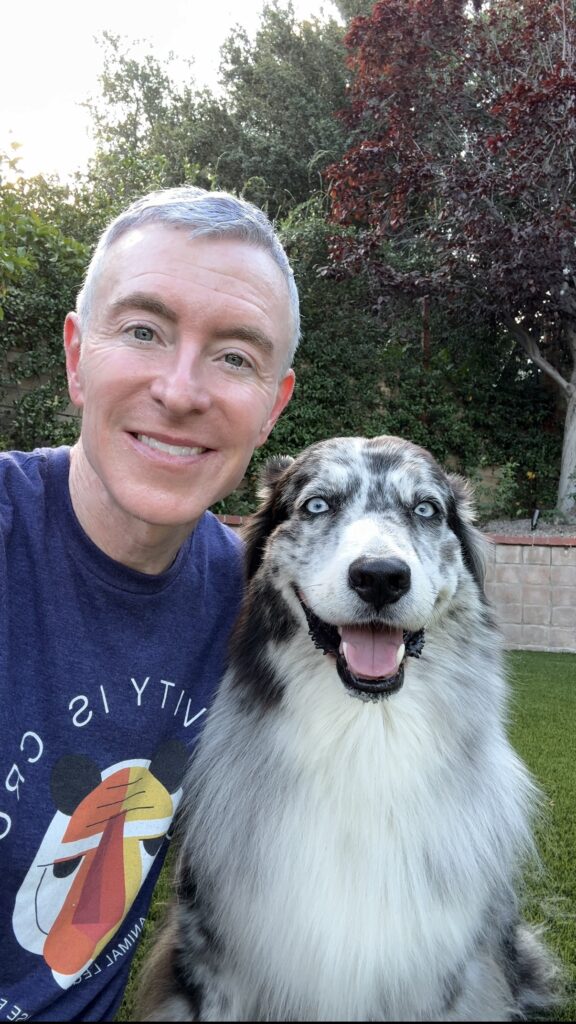 Man Smiling Outdoors with Dog