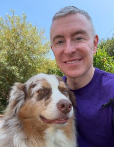 Man With Two Dogs Outdoors in a Sunny Setting