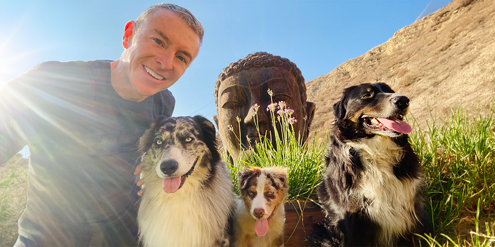 Michael R Burke with his dogs outside