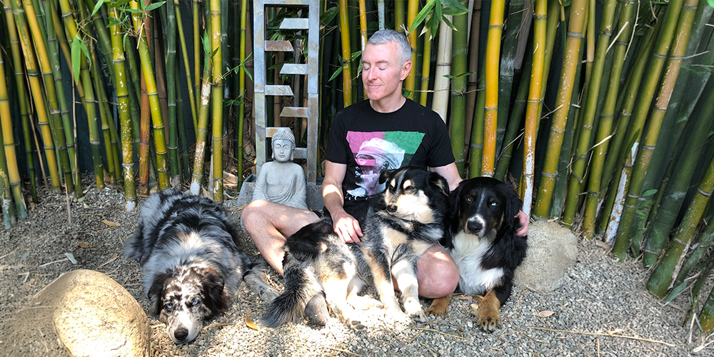 Michael R Burke relaxing with his dogs outside
