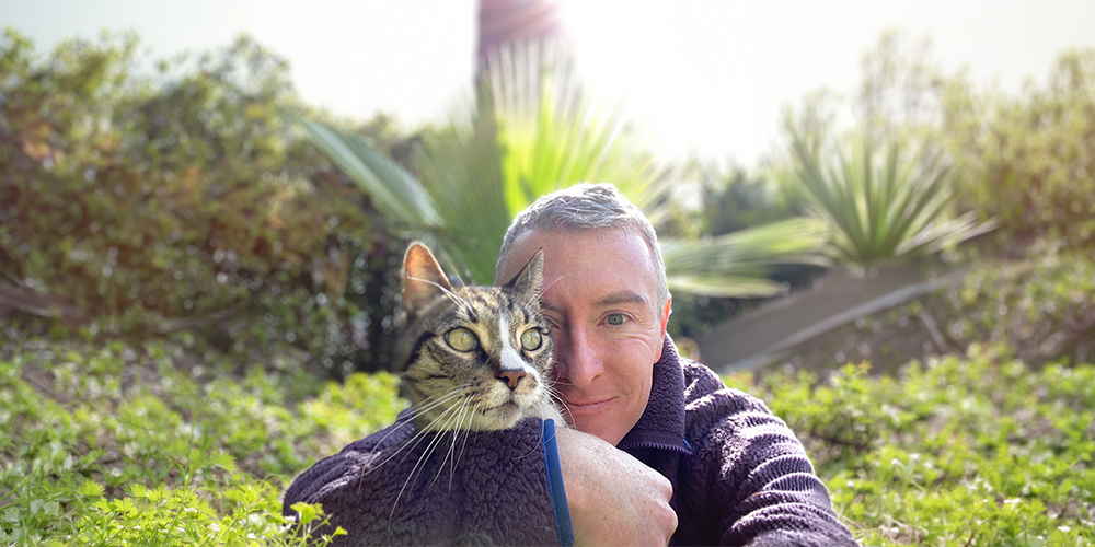 Michael R Burke meditating with his cat